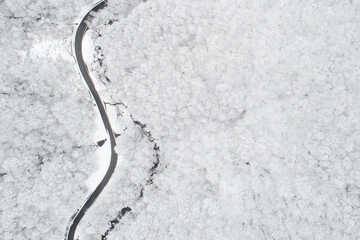 Aerial view of a road in the middle of the white forest