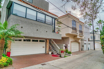 Fototapeta na wymiar Beautiful facade of two storey homes with attached garages in Long Beach CA