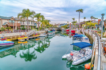 Small boats and boats with pedals at the docks of canal in Long Beach California - obrazy, fototapety, plakaty