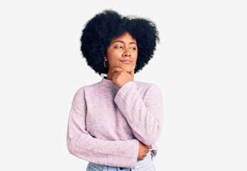 Young african american girl wearing casual clothes with hand on chin thinking about question, pensive expression. smiling with thoughtful face. doubt concept.