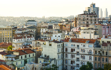 Fototapeta na wymiar Urban crowded city landscape in Istanbul. View so many apartments with red roof and mosques