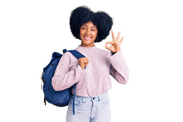 Young african american girl holding student backpack doing ok sign with fingers, smiling friendly gesturing excellent symbol