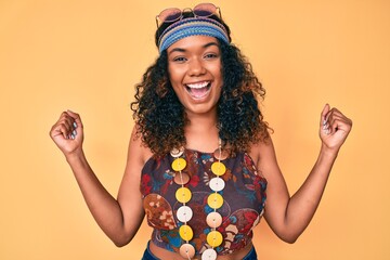Young african american woman wearing bohemian and hippie style screaming proud, celebrating victory...
