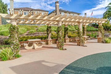 Pergola with vines and sitting areas in Huntington Beach California neighborhood
