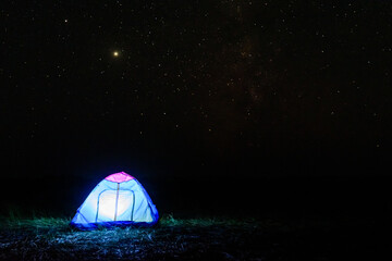 Tourist tent at night. Night sky with the many stars