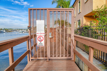 No Dogs and No Fishing signs on the gate of dock in Huntington Beach California