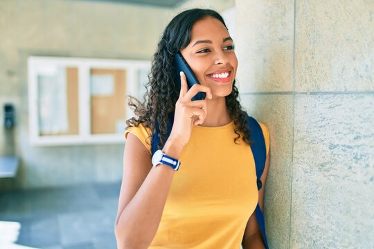 Young african american student girl smiling happy talking on the smartphone at university.