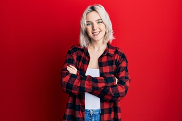 Young blonde girl wearing casual clothes happy face smiling with crossed arms looking at the camera. positive person.