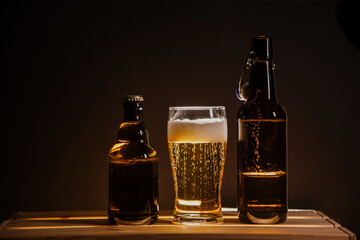 beer bottle on a wooden table and a glass of beer