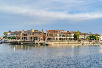 Fototapeta na wymiar Luxury houses with private docks and view of the sea in Huntington Beach CA