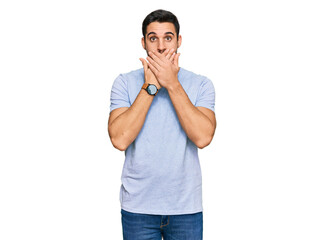 Young hispanic man wearing casual clothes shocked covering mouth with hands for mistake. secret concept.