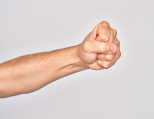 Hand of caucasian young man showing fingers over isolated white background doing protest and revolution gesture, fist expressing force and power