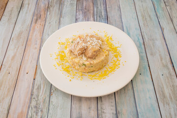 white plate with russian salad on wooden table