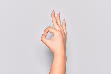 Hand of caucasian young woman gesturing approval expression doing okay symbol with fingers