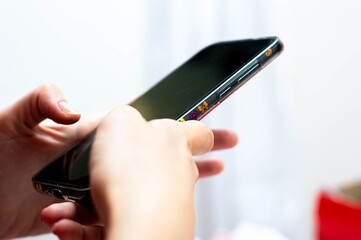 Woman hands with a cell phone taking notes