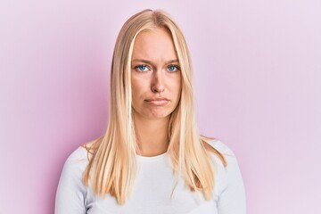 Fototapeta premium Young blonde girl wearing casual clothes depressed and worry for distress, crying angry and afraid. sad expression.