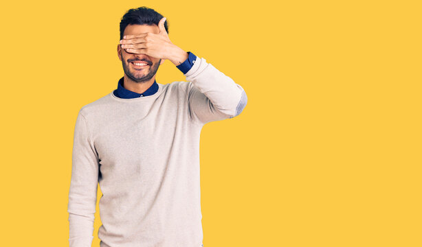Young handsome hispanic man wearing elegant clothes and glasses smiling and laughing with hand on face covering eyes for surprise. blind concept.
