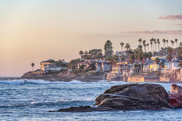 Scenic coastal landscape with buildings and houses ovelooking ocean at sunset