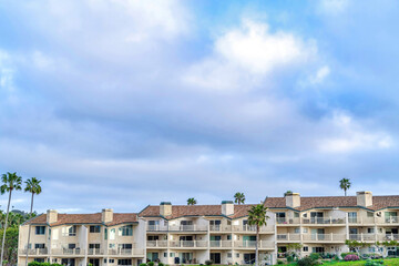 Fototapeta na wymiar Facade of residential building in San Diego California with clouds and blue sky