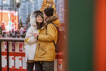 Obraz premium Happy cheerful and young caucasian couple are having fun while dating together outdoors in a city
