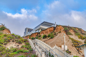 Fototapeta premium Waterfront house and mountain to beach stairs in scenic San Diego California