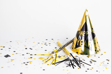 happy New Years hat with noisemakers and confetti on white background 