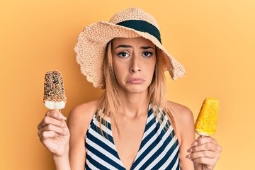 Beautiful blonde woman wearing summer style holding ice cream depressed and worry for distress, crying angry and afraid. sad expression.