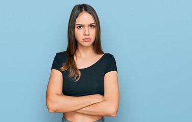 Obraz premium Young brunette woman wearing casual clothes skeptic and nervous, disapproving expression on face with crossed arms. negative person.