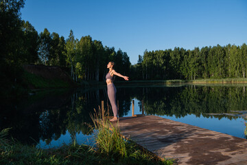 Fototapeta premium Calm young woman taking deep breath of fresh air relaxing meditating enjoying peace, serene tranquil girl doing yoga exercise feel no stress free relief