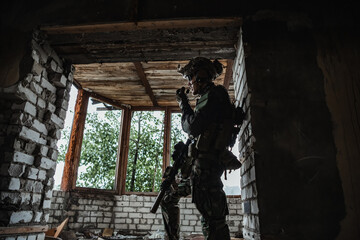 Military man standing inside the building and waiting for command.