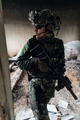 Front view close up of caucasian soldier with a rifle stand guard securing territory looking around.