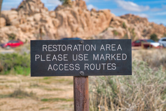 Restoration Area sign agaisnt desert landscape at Joshua Tree National Park