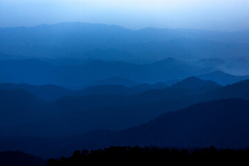 Fototapeta premium Dark Blue mysterious Mountain Landscape in cloudy sunset sky