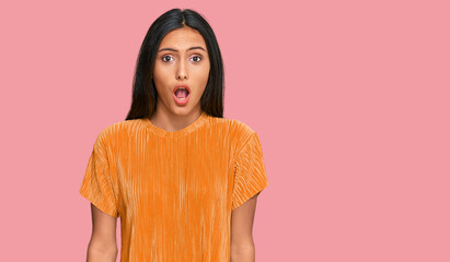Fototapeta premium Young brunette arab woman wearing casual clothes afraid and shocked with surprise expression, fear and excited face.