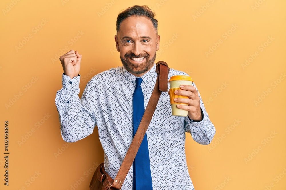 Sticker Handsome middle age business man wearing leather bag and drinking a take away cup of coffee screaming proud, celebrating victory and success very excited with raised arm