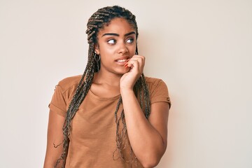 Young african american woman with braids wearing casual clothes looking stressed and nervous with...