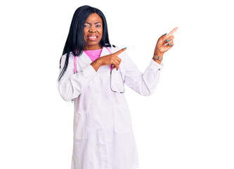 Young african american woman wearing doctor stethoscope pointing aside worried and nervous with...