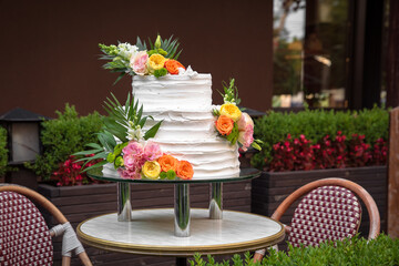 Fototapeta na wymiar Luxurious wedding or St. Valentine's naked cake decorated with fresh flowers