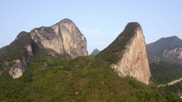 Chinese karst mountain landscape on sunny day, aerial reveal