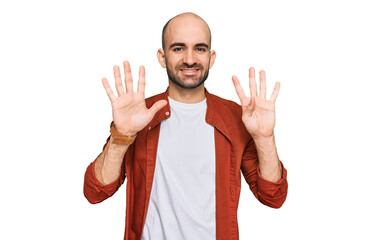 Young hispanic man wearing casual clothes showing and pointing up with fingers number nine while...