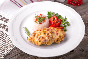 Chicken fillet baked in cheese with rice and vegetables. Balkan cuisine. National cuisine. Nourishing, useful, natural. Rustic cuisine.