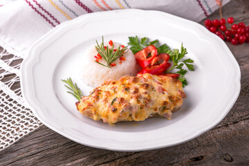 Chicken fillet baked in cheese with rice and vegetables. Balkan cuisine. National cuisine. Nourishing, useful, natural. Rustic cuisine.