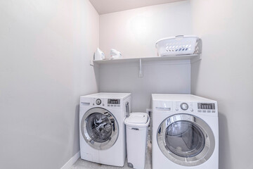 Small practical laundry room of house with washing machine and dryer appliances
