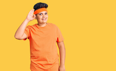 Fototapeta premium Little boy kid wearing sportswear smiling positive doing ok sign with hand and fingers. successful expression.