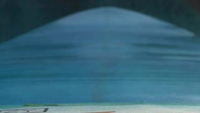 Close up slow motion shot of spray painting surfboard