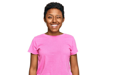 Young african american woman wearing casual clothes winking looking at the camera with sexy...