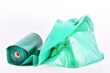 A close up image of large green dog poop bags on a white background. 