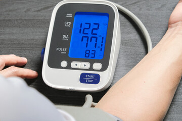 Man check blood pressure monitor and heart rate monitor with digital pressure gauge. Health care and Medical concept