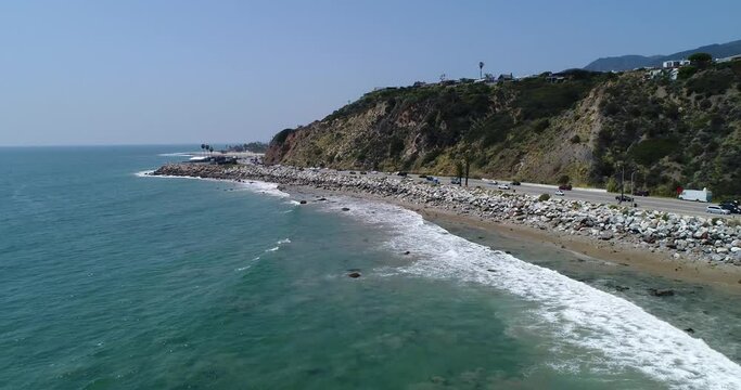 Drone shot what Big Dume Beach with town on the hill at California