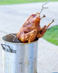 Pulling a deep fried turkey out of the fryer